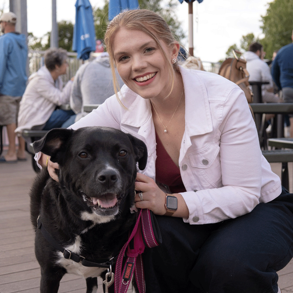 Olivia with dog at Senators game
