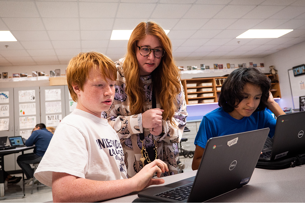 A teacher assists two young students with computer work at Franklin Special School District in Franklin, TN.