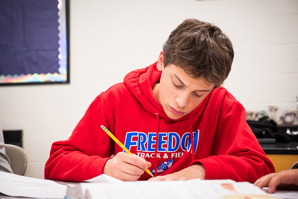 A male student athlete completes class work at Franklin Special School District in Franklin, TN.