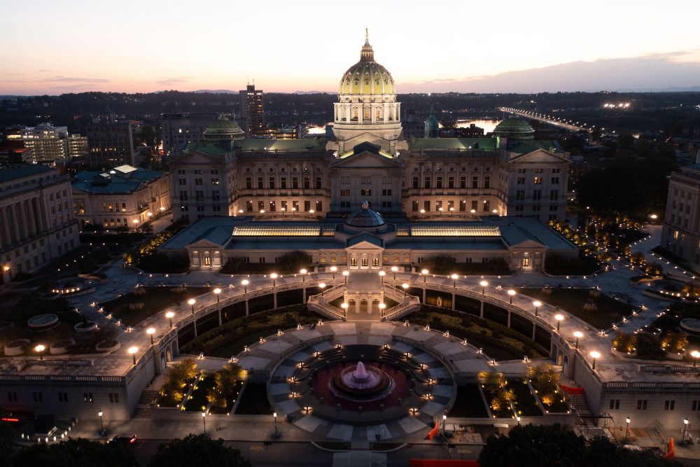 The Pennsylvania State Capitol lights up at dusk, as seen from the air, in downtown Harrisburg, PA.