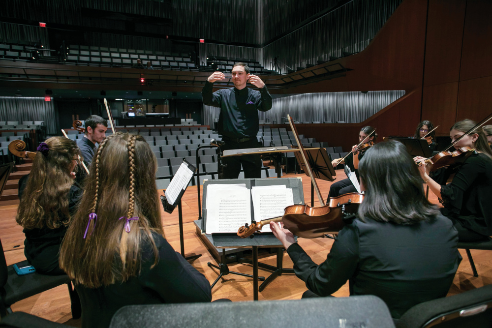 Conductor Michael T. Carney leads the Holy Cross Orchestra during a rehearsal before celebrating the 50th Anniversary of Coeducation with a concert at the Luth Concert Hall on November 16, 2022 at the Prior Performing Arts Center in Worcester, Massachusetts. (Photo by Michael Ivins/Holy Cross)