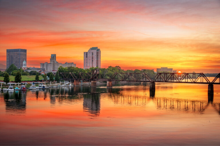 Augusta, Georgia, USA downtown skyline on the Savannah River at sunset.