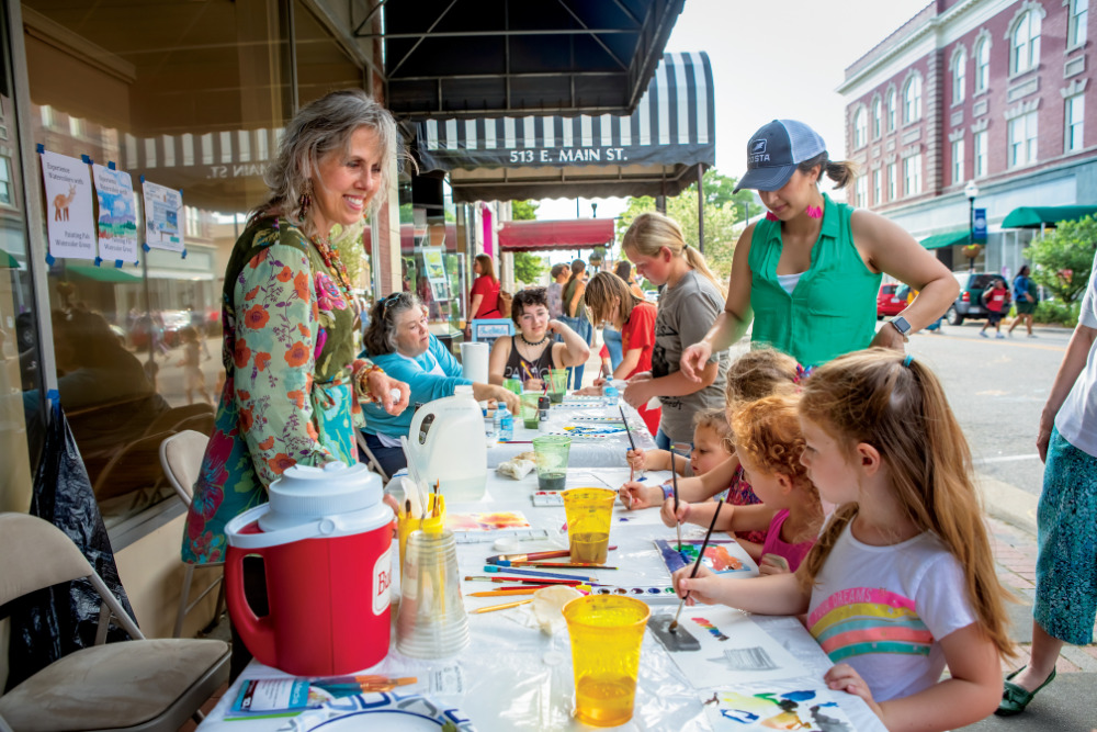 Children painting at an art walk event in downtown Elizabeth City, N.C.