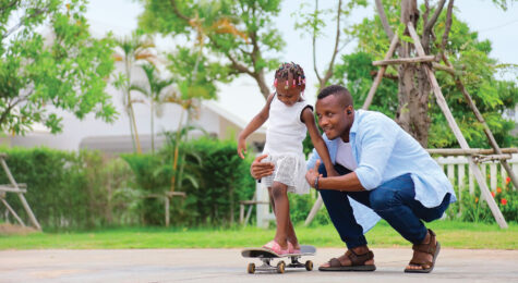Dad and daughter on skateboard