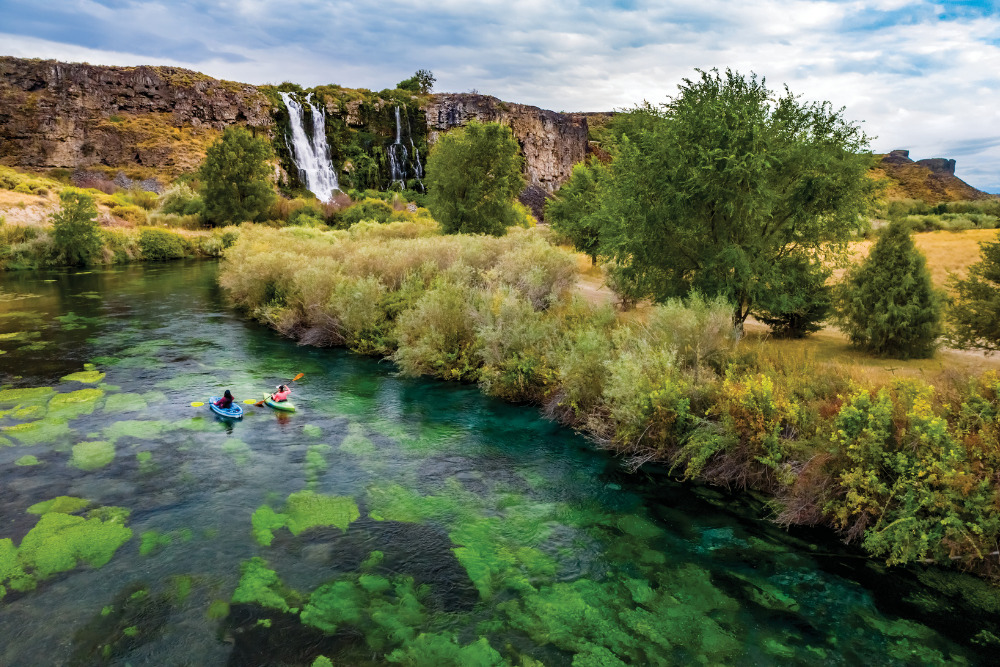 Kayakers paddle the crystal clear water near Lemon Falls at Thousand Springs State Park in Twin Falls, Idaho.