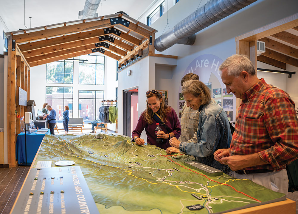 Visitors look at a trail map at the Damascus Trail Center in Virginia.