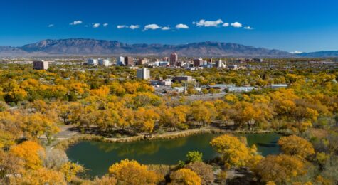 Albuquerque, New Mexico, during autumn with the downtown skyline and the Sandia Mountains in the distance.