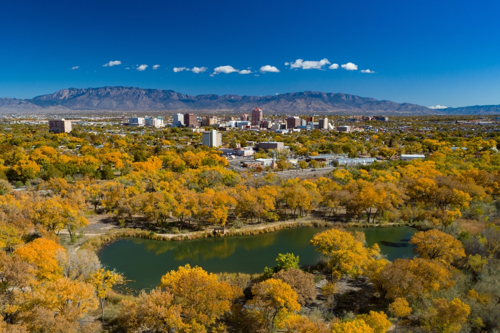 Albuquerque, New Mexico, during autumn with the downtown skyline and the Sandia Mountains in the distance. Albuquerque is one of the best places to live in New Mexico.
