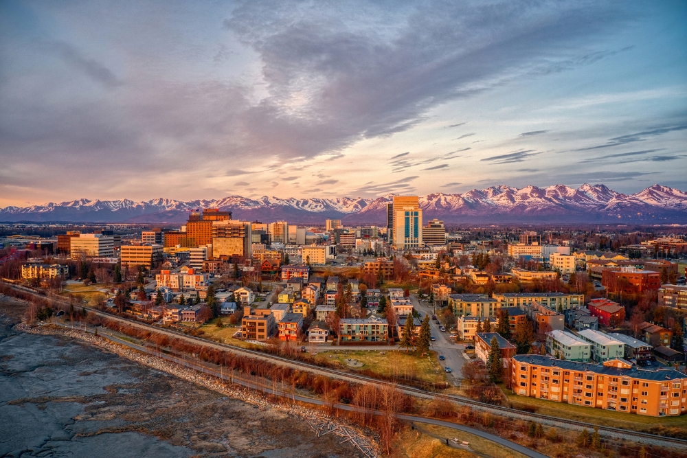 An aerial view of a sunset over downtown Anchorage, Alaska, during spring.