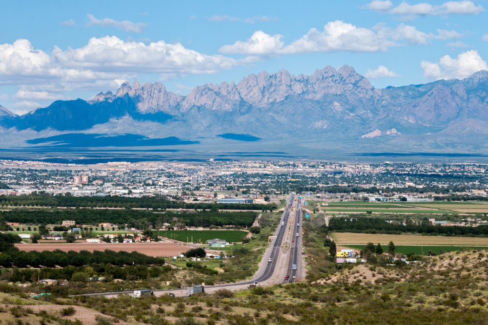 A scenic view of the city of Las Cruces, New Mexico, with the Organ Mountains in the distance.
