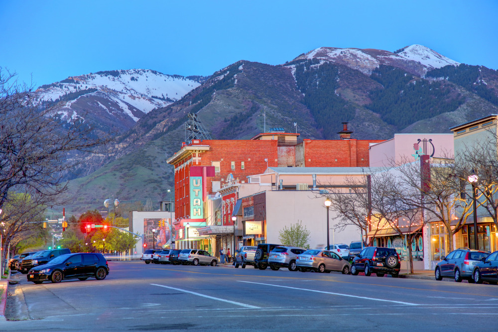 An evening view of storefronts along West Center Street in the downtown business district of Logan, Utah. logan is a best place to live in Utah.