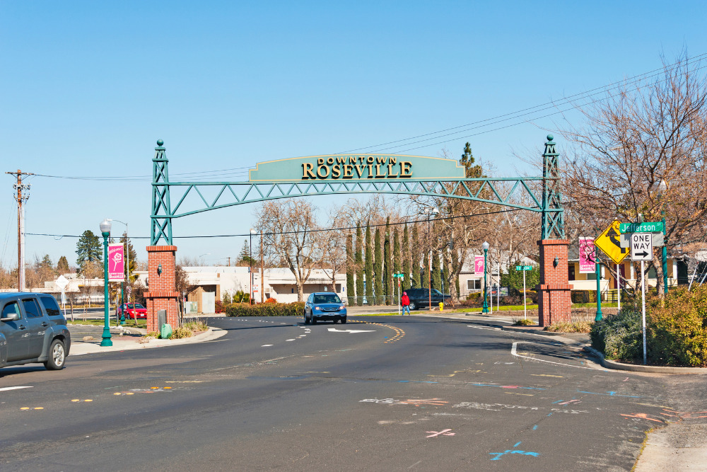 The downtown Roseville sign crosses the roadway, welcoming people to Roseville, CA. Rosewell is one of the best places to live in California.