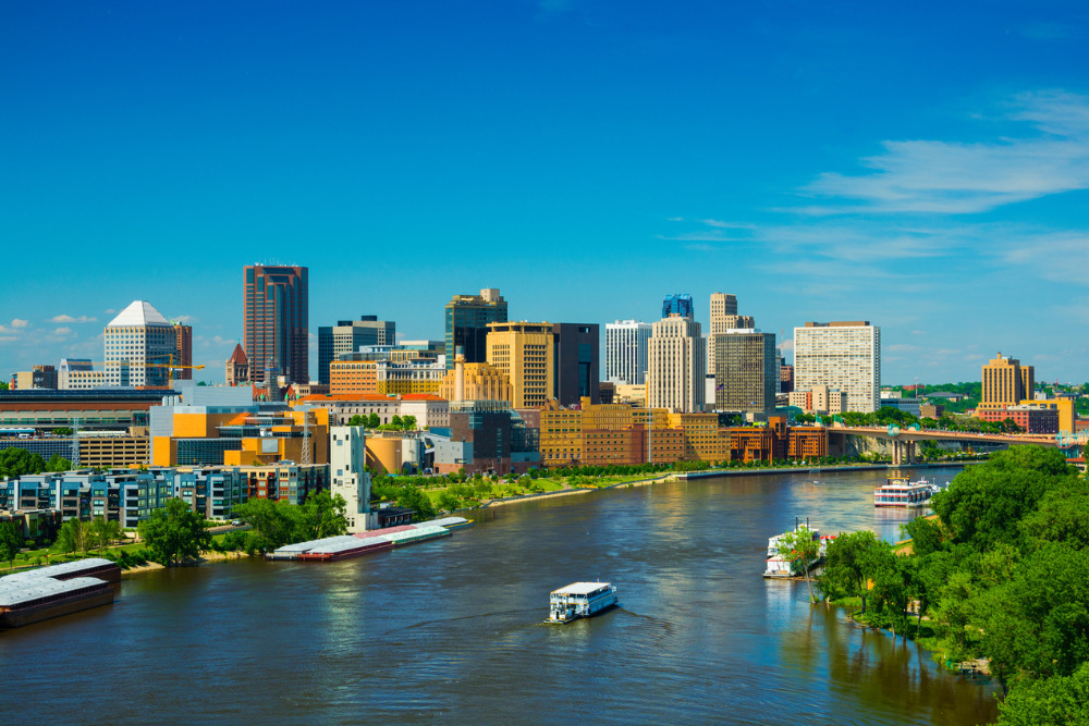 The downtown St. Paul, MN, skyline with the Mississippi River in the foreground. St. Paul is a great place to live in Minnesota.