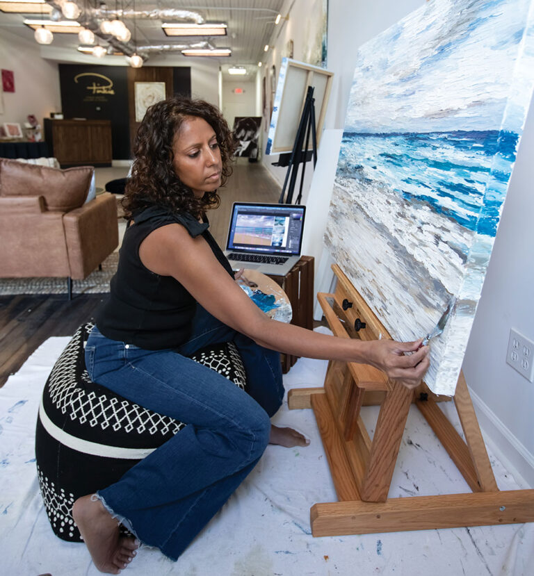 Pinkie Mistry uses a palette knife to paint a seascape in her gallery and studio in downtown Maryville, TN.