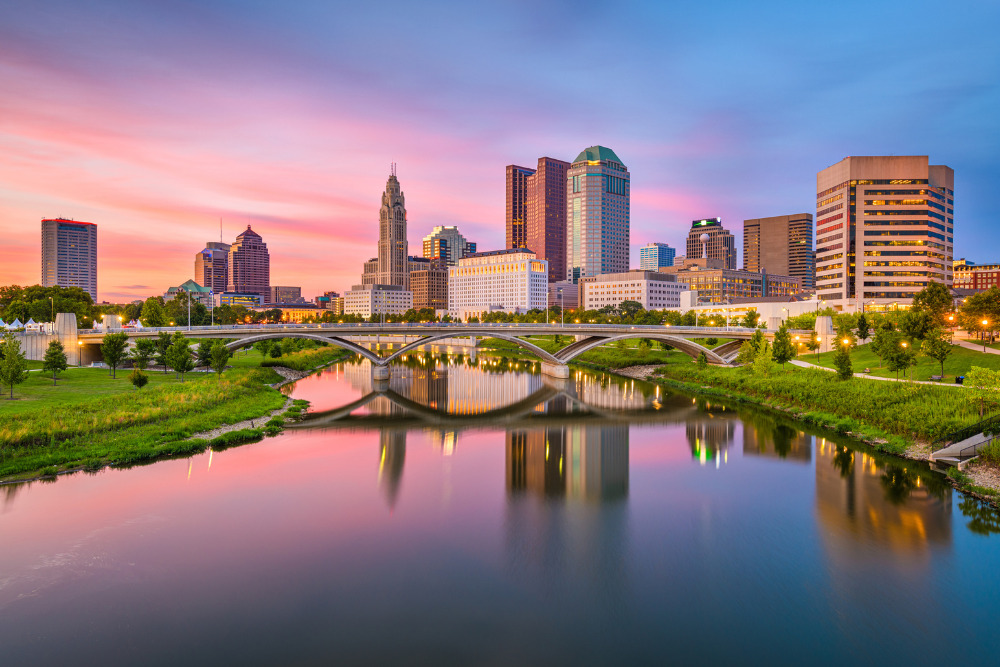 A view of the Columbus, Ohio, cityscape reflecting off the river at sunset. Columbus is one of the best place to live in Ohio.