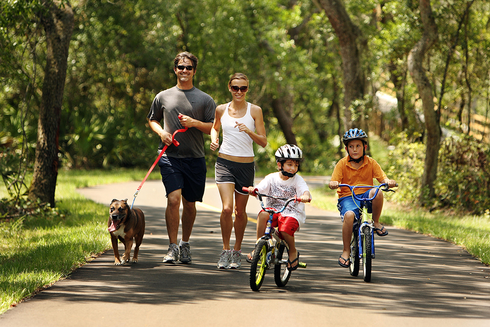 A family runs and rides bikes along the paved trail that runs from Blue Springs to Lake Beresford Park in West Volusia County. Families looking for things to do in central Florida won't be disappointed.