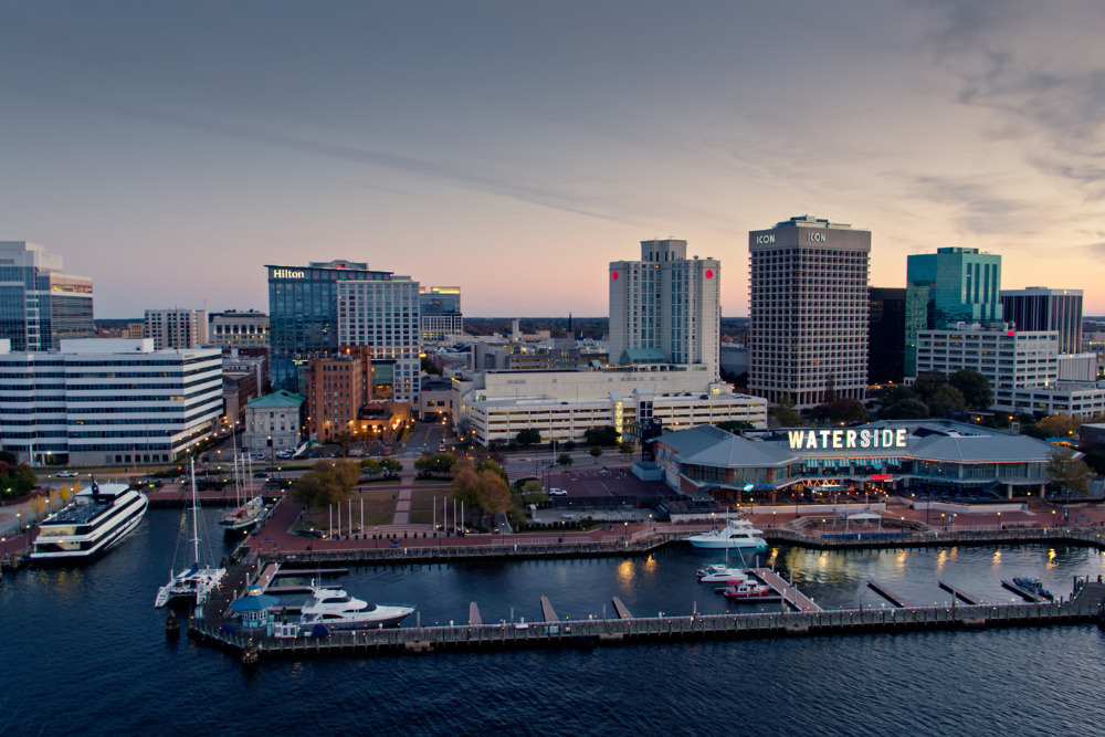 An aerial shot of Downtown Norfolk, Virginia, from over the Elizabeth River at sunrise. Norfolk is a great city to live in Virginia.