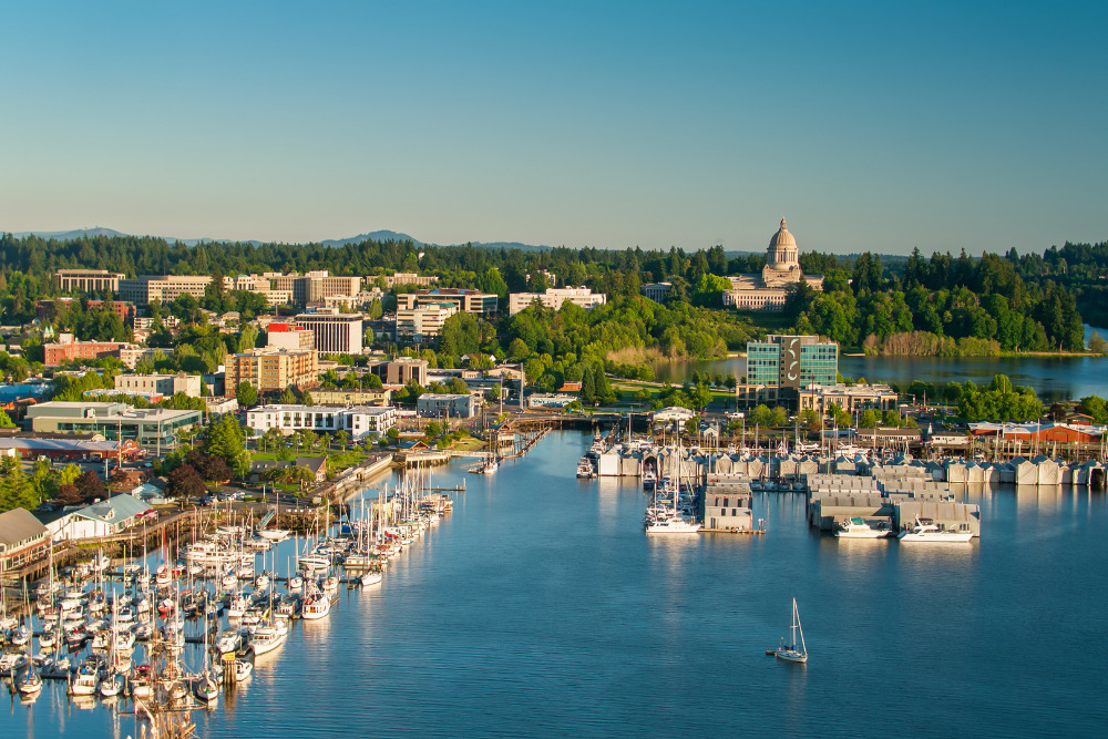 Aerial shot of Olympia, Washington on a summer evening, looking across the downtown towards the state capitol building.