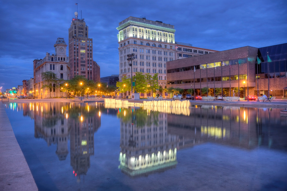 The cityscape reflects on the water in Syracuse, New York.