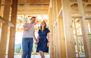 Couple in framework of new home
