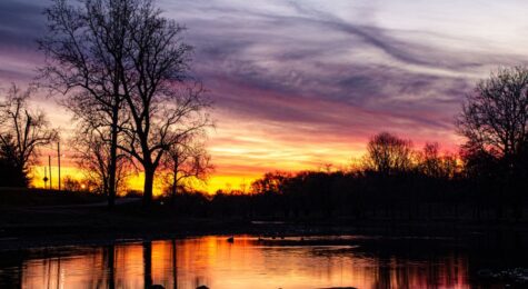Photo of a sunset over water in Muncie, Indiana.