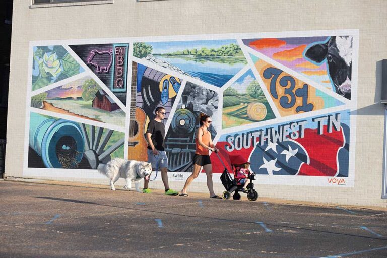 Jackson, TN, is family-friendly. A family walks past the Southwest TN mural in downtown Jackson, Tennessee.