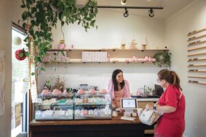Raina Schultz of Sprinkle Me Sugar helps a customer with a macaron order in Jackson, Tennessee.