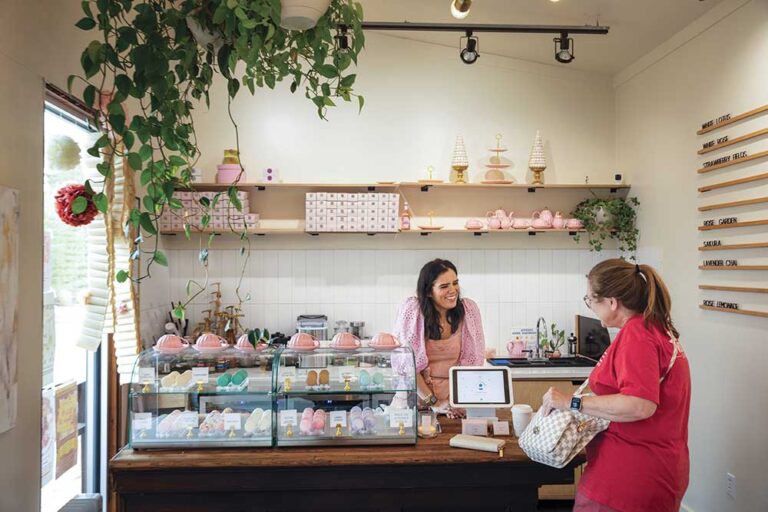 Raina Schultz of Sprinkle Me Sugar helps a customer with a macaron order in Jackson, Tennessee.