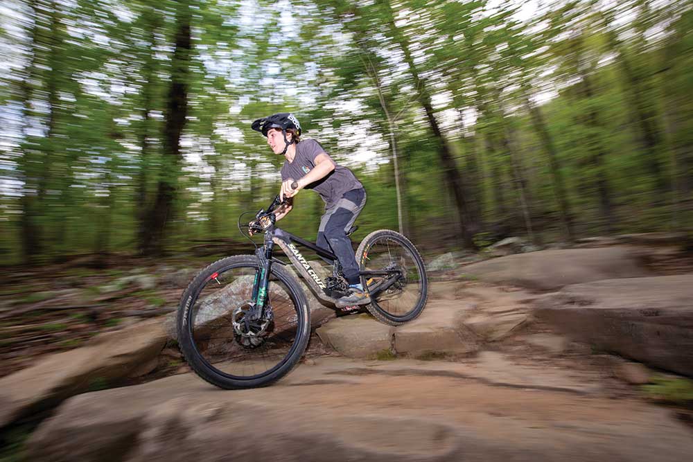 Sam Laramore rides his mountain bike on the Biscuits and Gravy trail while practicing with the Huck & Braaap Cycling team at Walden’s Ridge Park in Signal Mountain.