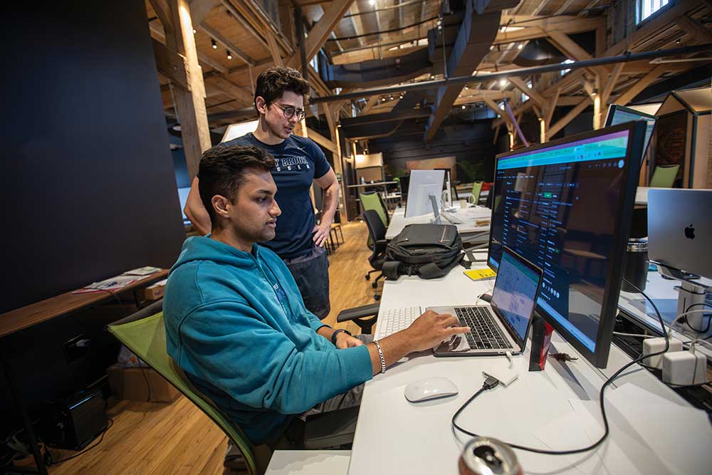 Kyle Malik, front, and Nicholas López works in the start-up space for Prosal inside the Brickyard in Chattanooga. ©Journal Communications/Nathan Lambrecht
