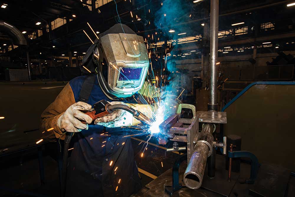 Komatsu pre-apprenticeship program student Samuel Herron works on a welding station in Komatsu America Corporation’s manufacturing plant in Chattanooga. The apprenticeship program is targeted at filling Chattanooga manufacturing jobs. ©Journal Communications/Nathan Lambrecht