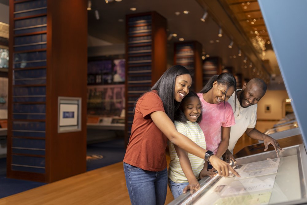 A family looks at exhibits at the William J. Clinton Presidential Library & Museum, one of many things to do in Little Rock AR.