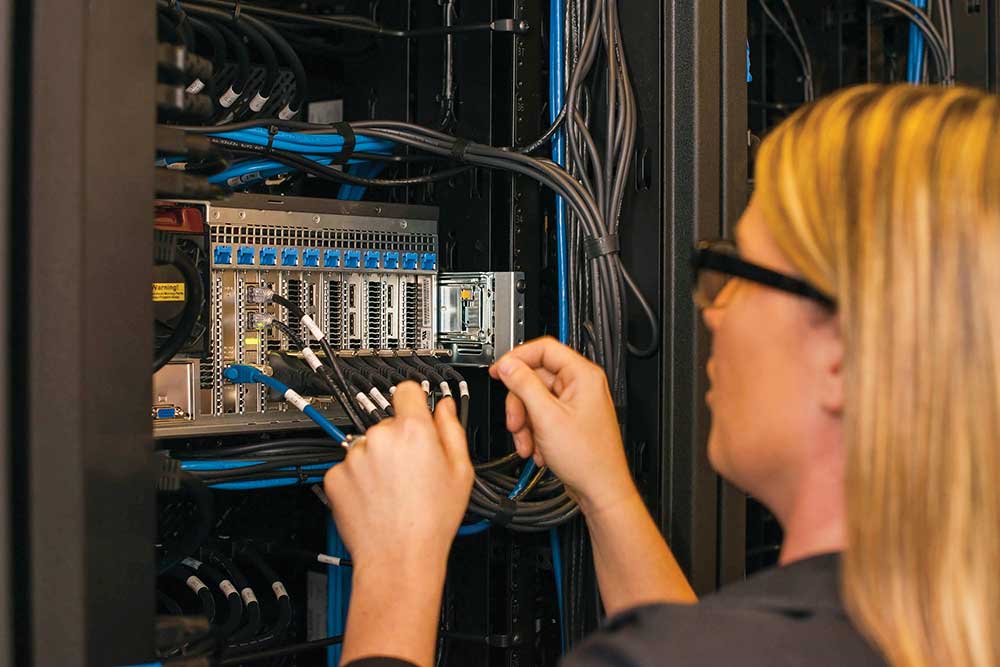 Woman working at Mechdyne. Mechdyne, founded in 1996 by three Iowa State University graduates, creates technology solutions for clients worldwide.