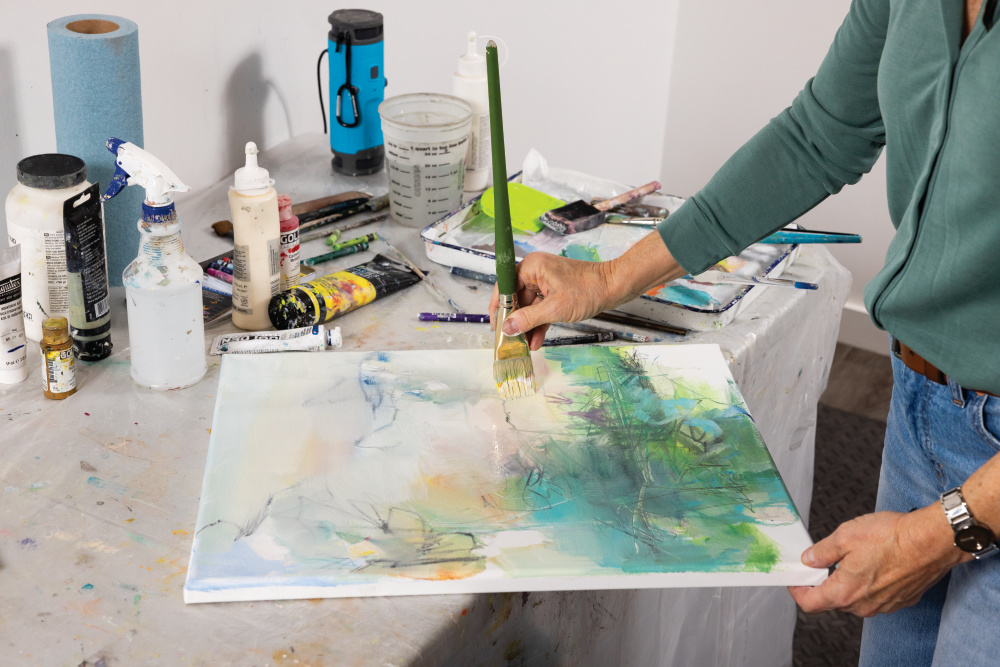 Donna Wisener paints a new painting at Art at 101 in the Factory at Columbia in Columbia, Tennessee.