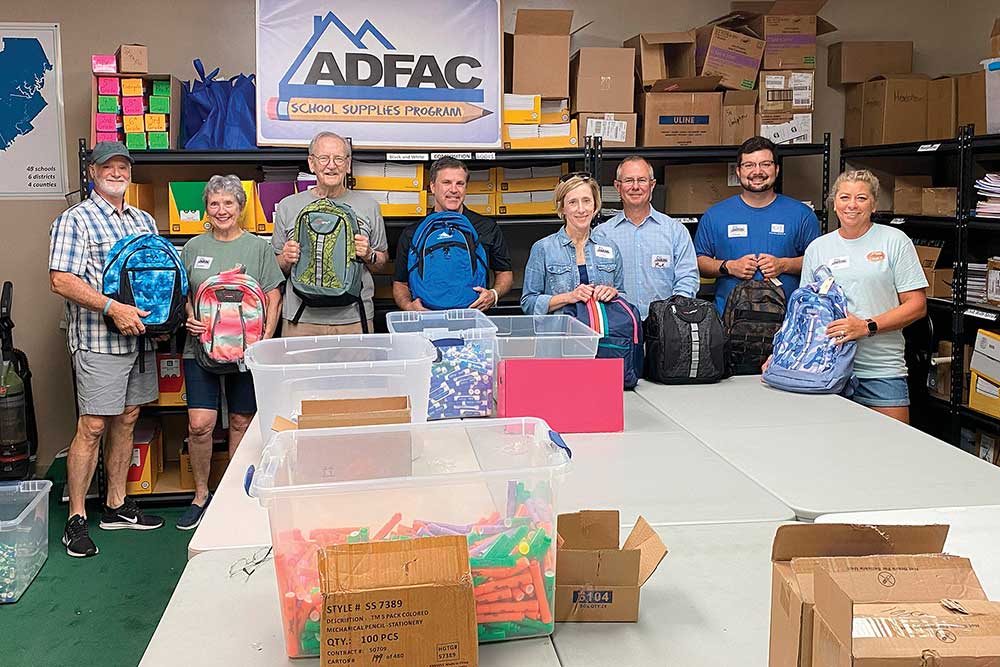 Volunteers from C&J Wealth Advisors helped pack dozens of backpacks for ADFAC’s School Supplies Program