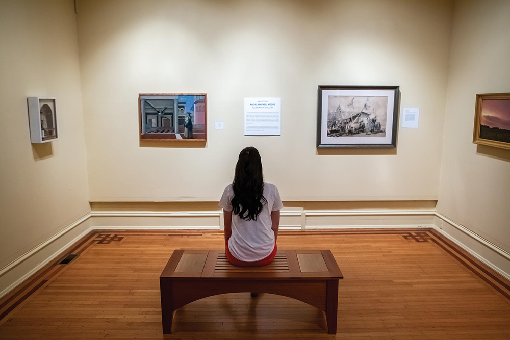 A young woman looks at art at Greenville Museum of Art in Greenville, NC