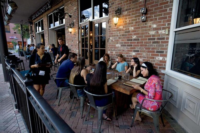 Diners sit on the patio at Dragonfly Sushi, one of many great restaurants in Gainesville, FL.