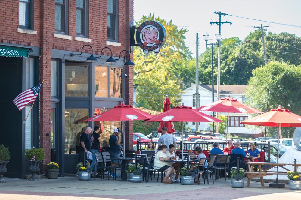 Visitors dine outdoors at Dr. Rolf's Barbecue in downtown Muskegon.