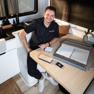 Brian Fuentes sits in one of all-electric Coast travel trailers that he manufactures in Nashville.