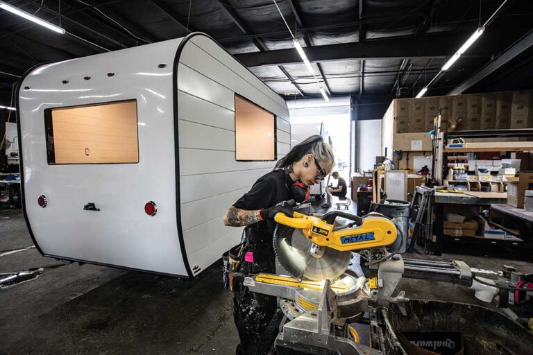 Keunarene Benitez cuts a piece of interior trim for a mobile business trailer at Aero Build in Nashville.