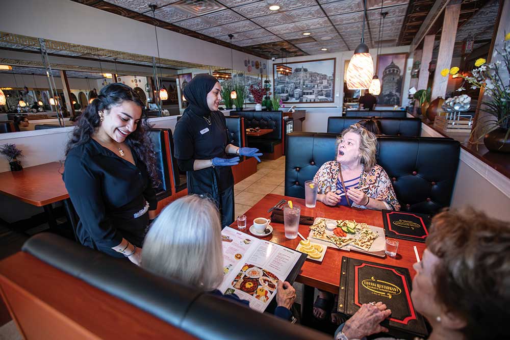 Rana Karakoyun, center, serves Liz Maddox an appetizer at Edessa in Nashville.