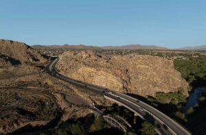 The Rainbow Bridge crosses the Mojave River next to Califfornia State Route 18 between Victorville and Apple Valley in Victorville, California. Drone photo.