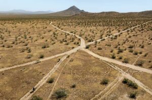 Mountain bikers ride the rocky trails at Bell Mountain in Apple Valley, California. Drone photo.