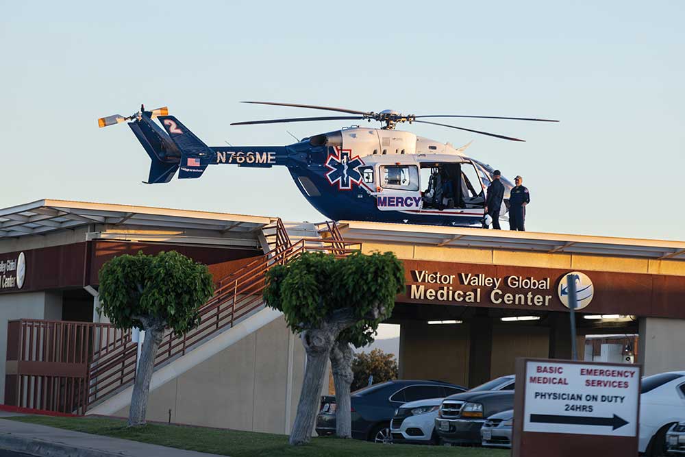 Helicopter pilots prepare for flight on top of the Victor Valley Global Medical Center in Victorville, California.