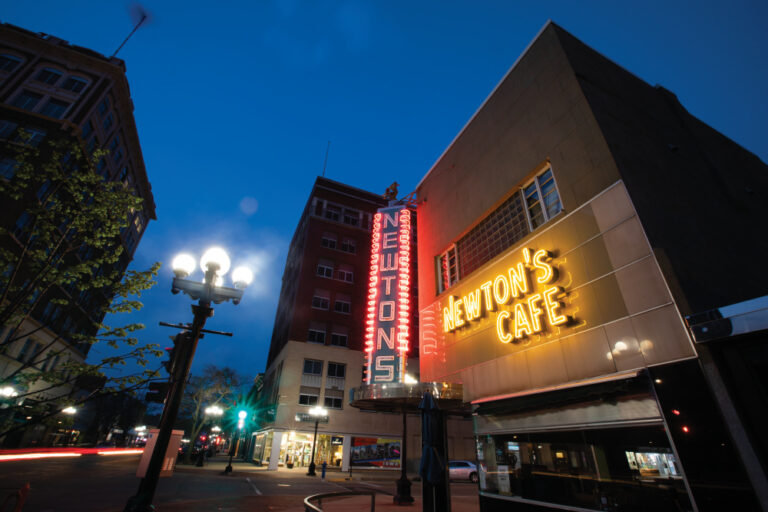 Newton's Cafe lights up at dusk in downtown Waterloo, Iowa.