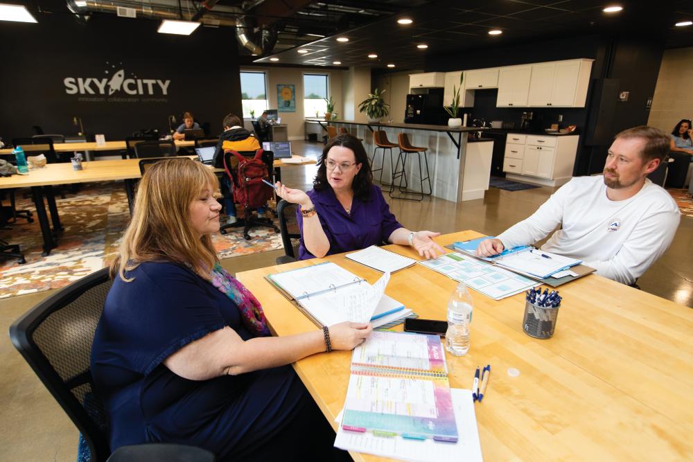 Shannon Bryant, center, meets with business owners Yvonne Smith, left, and Daniel Ritchey at the Sky City Entrepreneur Center in downtown Maryville, TN.