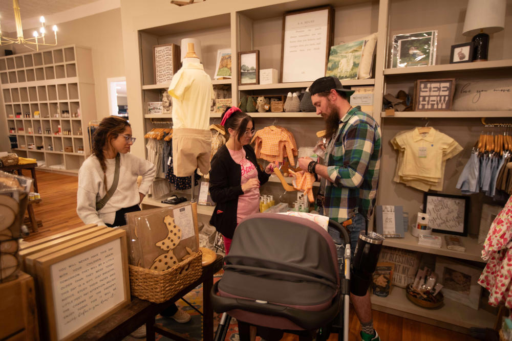 Christian and Amber Blair shop for clothing for their 2-month-old daughter with a friend at the J. Danforth Mercantile in downtown Maryville, TN.