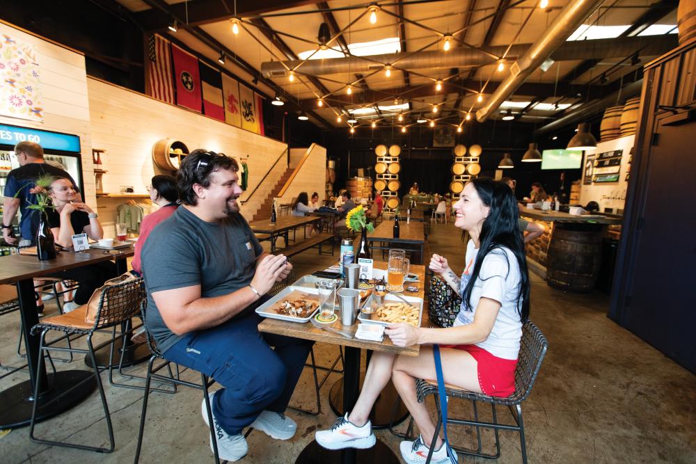 Josh Langley, left and Angela Aikens play a game together while enjoying dinner at Peaceful Side Brewery in Maryville. ©Journal Communications/Nathan Lambrecht