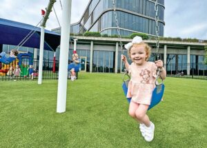 Little girl on the swings at SRM Concrete Christian Academy.