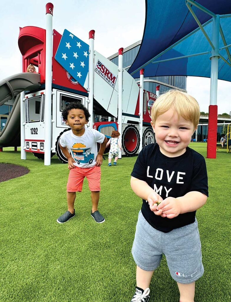 Two small children play on the playground at SRM Concrete Christian Academy.